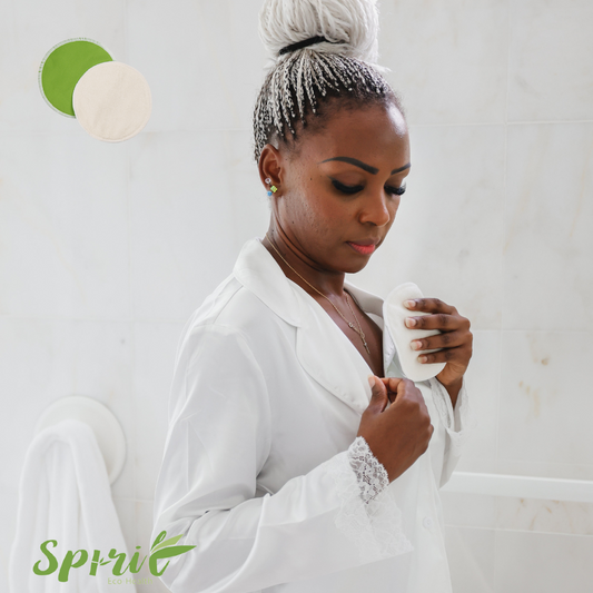 A black stylish woman wearing white pajamas putting nursing pad inside her clothes