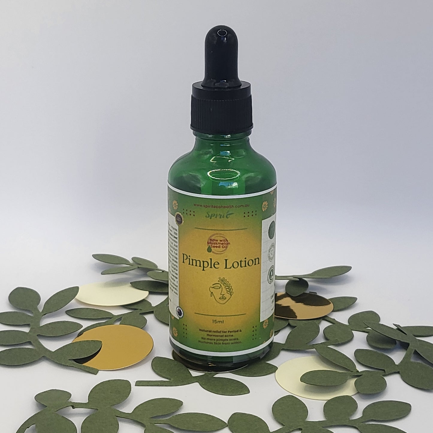 Spirit Acne Serum 50 ml next to green & golden confetti 