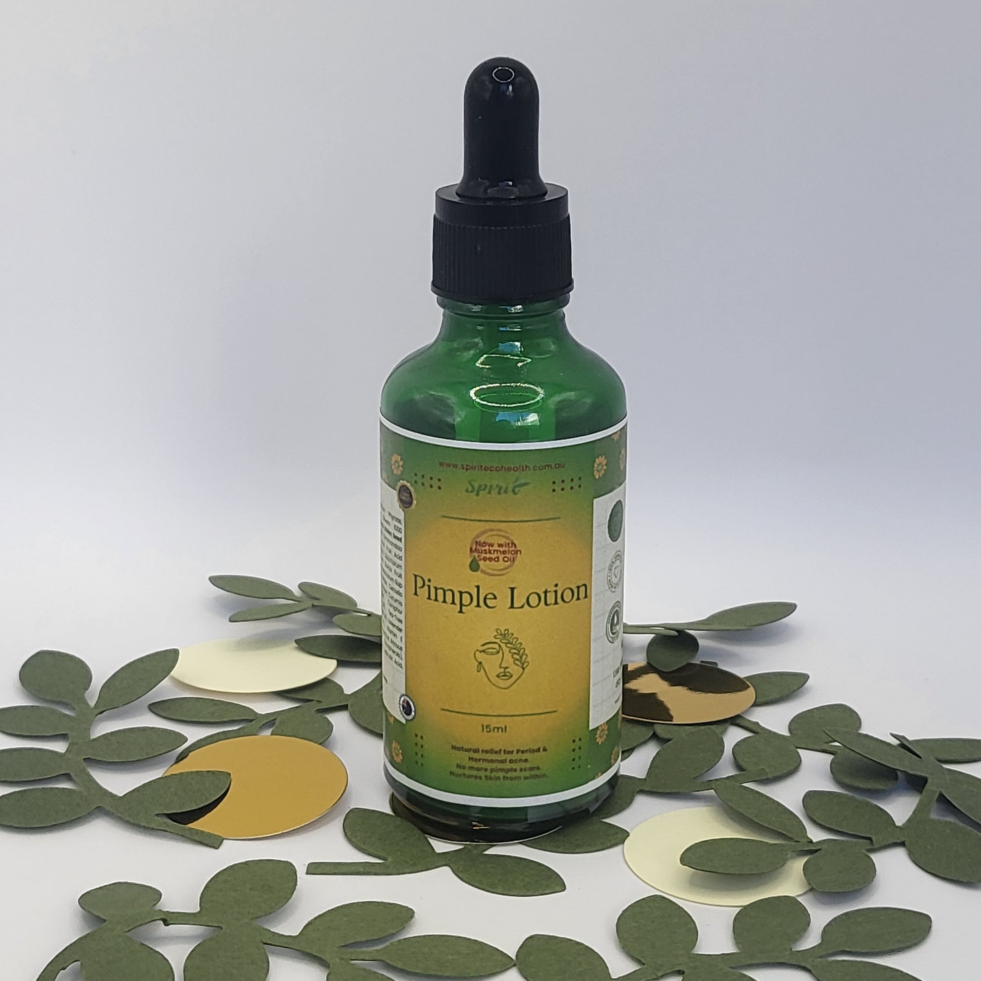 Spirit Acne Serum 50 ml next to green & golden confetti 