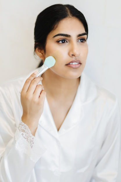 Woman putting Spirit Acne Beauty Mask on her face with a spatula