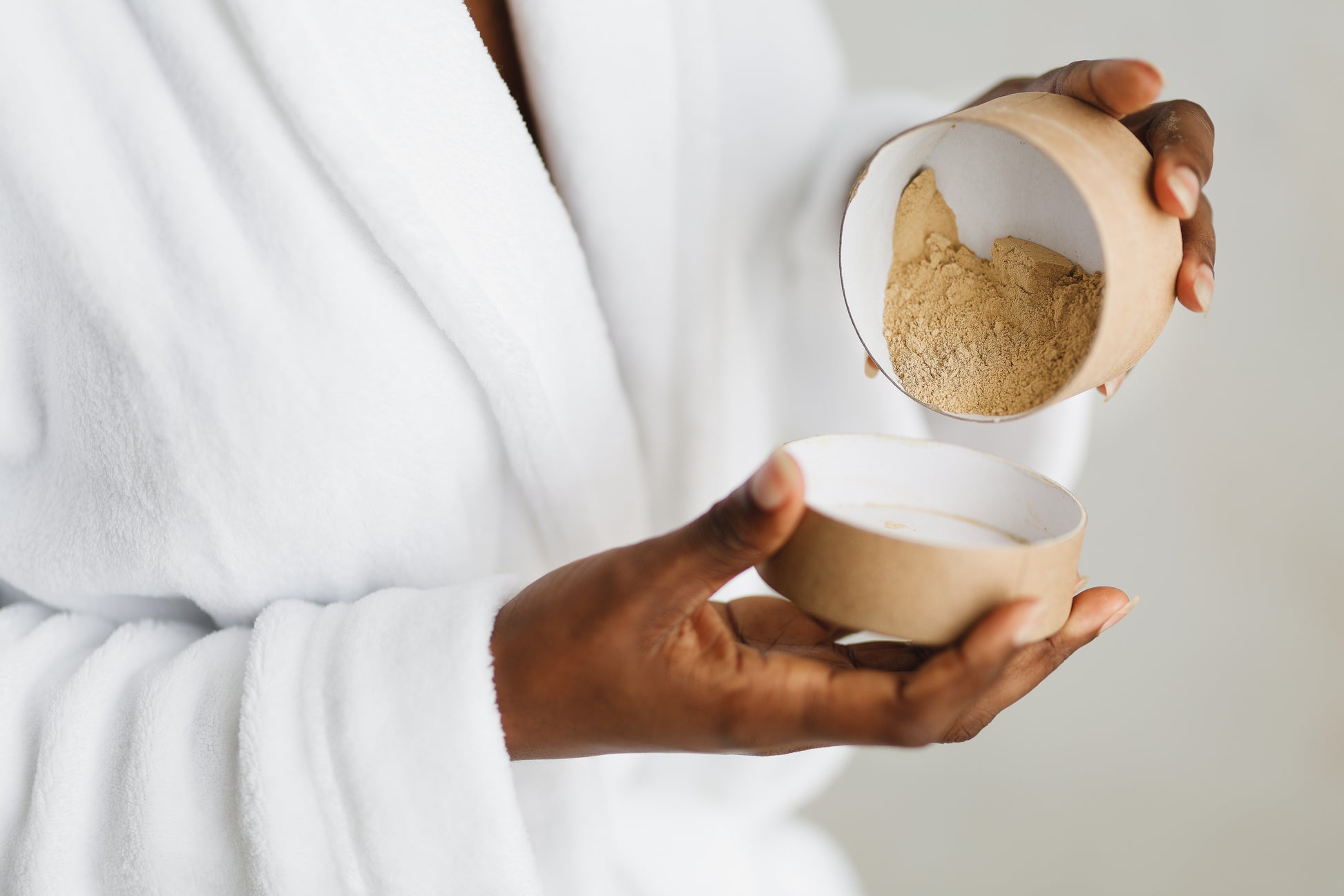 a woman sprinkling spirit period acne beauty mask